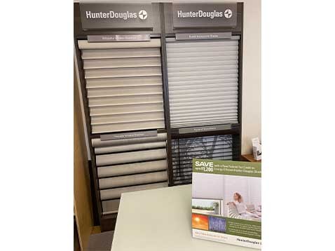 A display of multiple Hunter Douglas window coverings